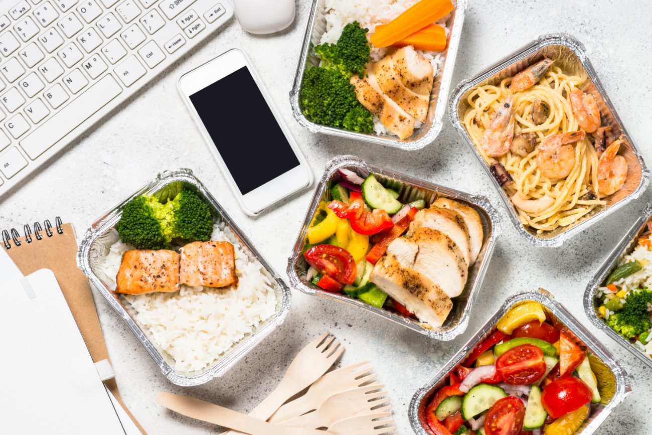 Healthy meal-prep containers arranged on a workspace